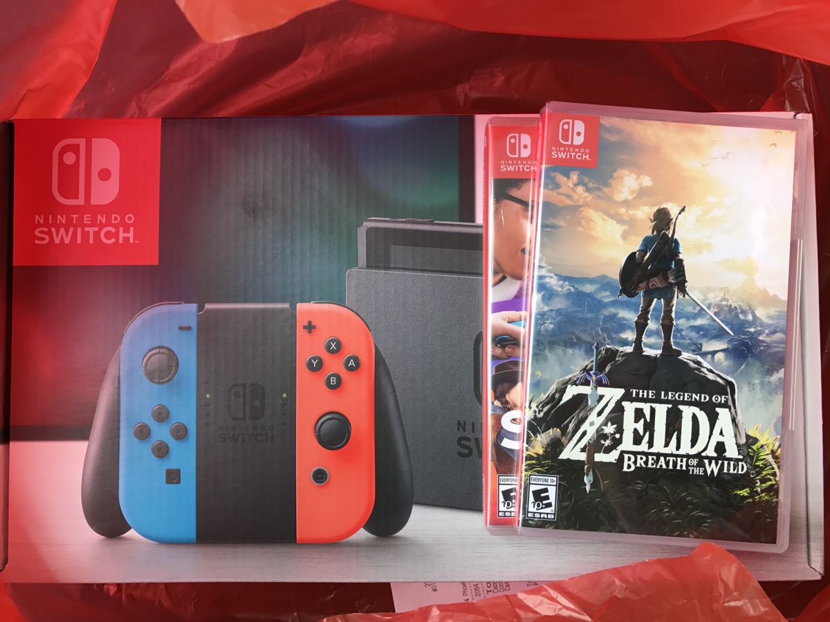 A photo of the Nintendo Switch in a bag with a copy of Zelda Breath of the Wild