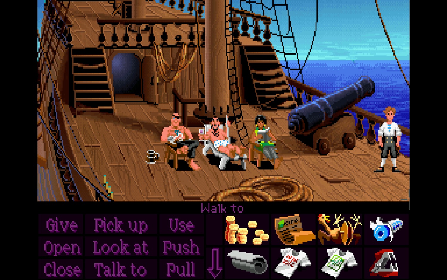 A screenshot of the original version of the Secret of Monkey Island where Guybrush is on his ship and the rest of the crew are ignoring him and sunbathing