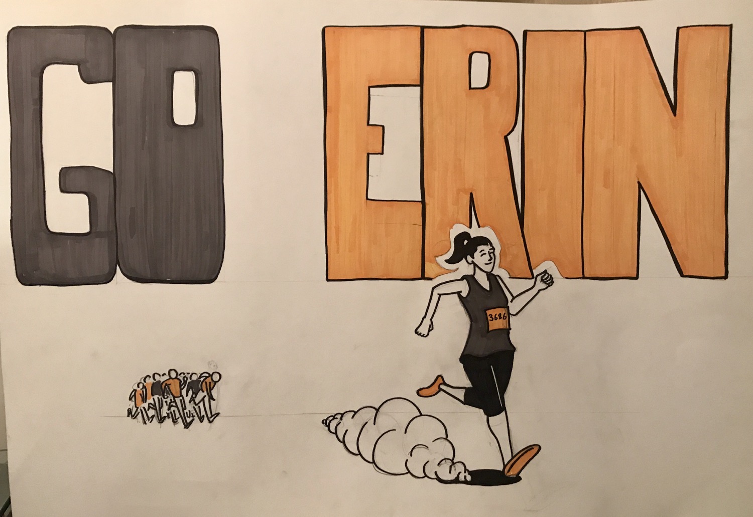 A photo of an illustrated sign I made for Erin's half marathon on Sunday. It says "GO ERIN" and has a picture of her running ahead of a crowd.